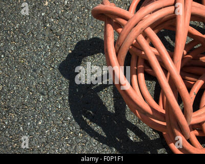 The Orange Extension Cord on the Ground at the Constructionsite Stock Photo