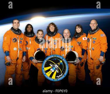 Group portrait of the STS-131 space shuttle crew astronauts in launch-and-entry suits are: Front Row: James P. Dutton Jr., (left) and Alan Poindexter,  (standing from left) Rick Mastracchio, Stephanie Wilson, Dorothy Metcalf-Lindenburger, Japan Aerospace Exploration Agency astronaut Naoko Yamazaki and NASA astronaut Clayton Anderson at the Johnson Space Center October 21, 2009 in Houston, Texas. Stock Photo