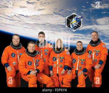 Group portrait of the STS-130 space shuttle crew astronauts in launch-and-entry suits are (L to R): Nicholas Patrick, Terry Virts, Robert Behnken, Kathryn Hire, George Zamka and Stephen Robinson at the Johnson Space Center August 4, 2009 in Houston, Texas. Stock Photo