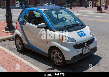 A Car2Go Smart Fortwo car parked on the street waiting for its next car sharing driver in Columbus, Ohio. Stock Photo