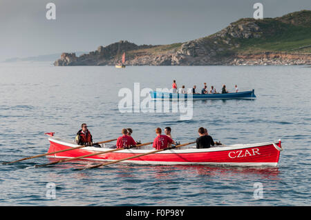 The start of a pilot gig race from Hugh Town, St Mary's to Tresco in beautiful evening light. Stock Photo