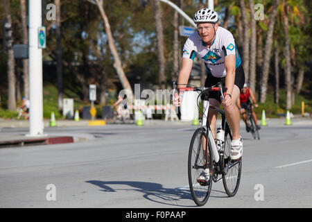 Determined Male Cyclist Competing In The Long Beach Triathlon. 16 August 2015. Stock Photo