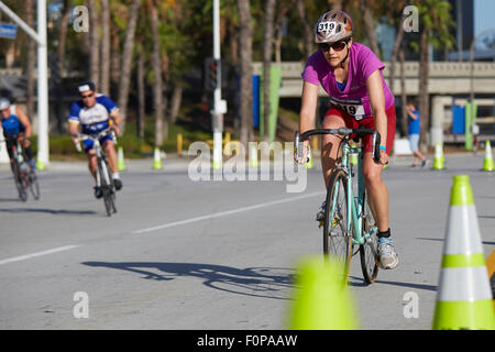 Determined Female Cyclist Competing In The Long Beach Triathlon. 16 August 2015. Stock Photo