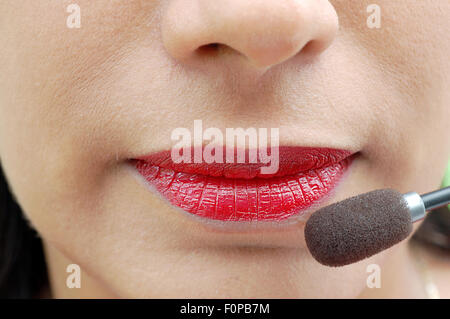 macro shot of woman's lips and a microphone Stock Photo