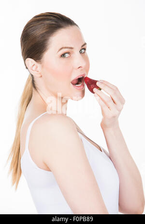 young woman eating strawberry Stock Photo