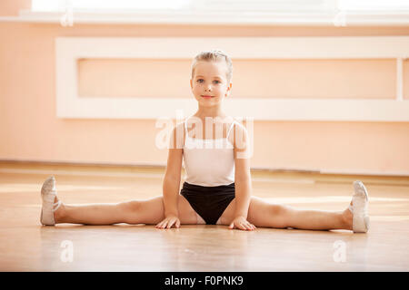 little ballerina girl doing stretching Stock Photo - Alamy