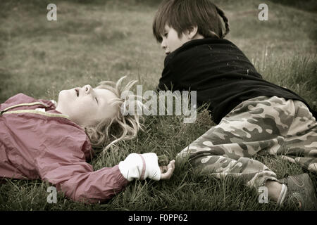 Children playing in a grassy field Stock Photo