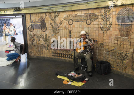 Busking,busker,and blanket,man,men,manteros,Local train services and underground train stations in Barcelona,Catalonia,Spain. Stock Photo