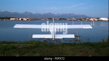 A plane sits waiting for the next chance to be of service as darkness falls on Anchorage Stock Photo