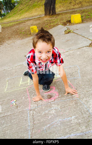 cute boy playing hopscotch Stock Photo