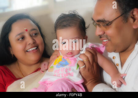 Portrait of a happy family showing father mother and their baby boy sharing joy and happiness with copy space Stock Photo