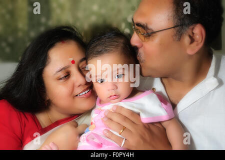 Portrait of a happy family showing father mother and their baby boy sharing joy and happiness with copy space Stock Photo