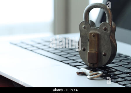 Internet security concept-old padlock and key on laptop computer keyboard Stock Photo