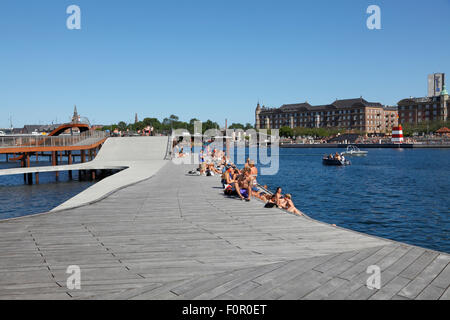 Kalvebod Waves at Kalvebod Brygge in Copenhagen. Islands Brygge Harbour Bath to the right on the opposite harbour canal quayside. Public urban beach. Stock Photo