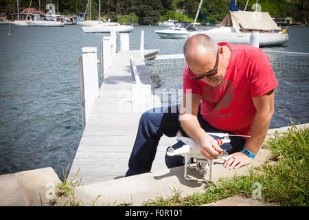 Drone camera being set up ready for flight with drone operator in the shot Stock Photo