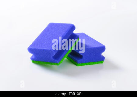 two blue kitchen sponges on white background Stock Photo