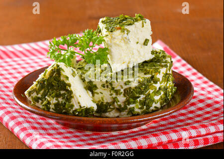 fresh cheese coated in chives and garlic Stock Photo