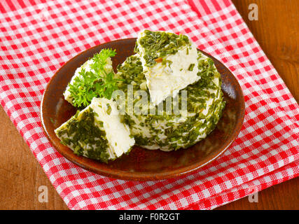 fresh cheese coated in chives and garlic Stock Photo