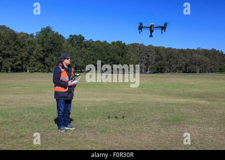 Drone operator flying a DJI Inspire quad copter Stock Photo