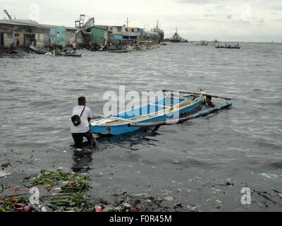 Navotas City, Philippines. 20th Aug, 2015. Filipino fishermen align their boat towards the Manila Bay in Navotas City, north of Manila, Philippines. Typhoon Goni has slowed down after entering the Philippine Area of Responsibility (PAR) on Tuesday, and is expected to become a super typhoon over the weekend as it travels through the northern Luzon island in the Philippines, slightly hitting Taiwan, then heading north towards Japan and South Korea. Credit:  Richard James Mendoza/Pacific Press/Alamy Live News Stock Photo