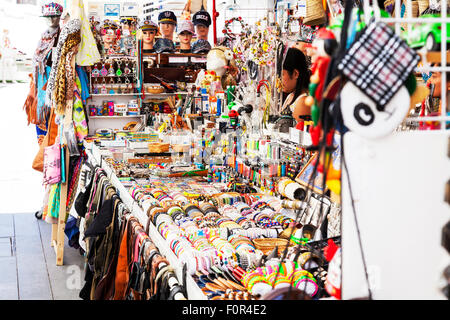 Tourist tat junk rubbish for sale on stall in Ibiza Town Spain Spanish market bracelets scarfs hats key rings Stock Photo