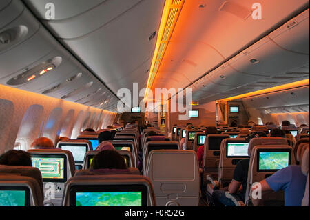 Boeing 777-300 passenger compartment economy class during flight Dubai-Frankfurt Stock Photo