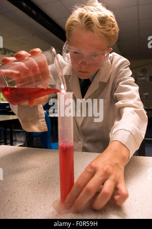 Secondary school pupil undertaking a science experiment in the laboratory, Surrey, UK. Stock Photo