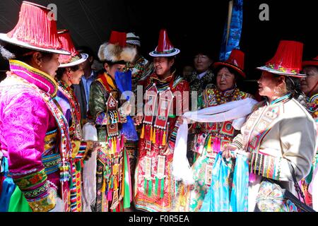 Yugur, Gansu, CHN. 18th Aug, 2015. Yugur, CHINA - August 18 2015: (EDITORIAL USE ONLY. CHINA OUTï¼‰Successor of Intagible Cultural Heritage Ke Cuilin held a wedding for her daughter, passing on the wedding heritage to the 90s youth on August 18 2015 morning. the Yugur ethnic minority group is heir of Uighur ethinic group, and divided as Western Yugur and Eastern Yugur mainly in Yugur Autonomous County Gansu. In 2011 their traditional wedding customs were on the 3rd National Intagible Cultural Heritage List. They insist monogamy, men and women share same Family name and same origin, or differe Stock Photo