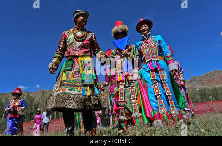 Yugur, Gansu, CHN. 18th Aug, 2015. Yugur, CHINA - August 18 2015: (EDITORIAL USE ONLY. CHINA OUTï¼‰Successor of Intagible Cultural Heritage Ke Cuilin held a wedding for her daughter, passing on the wedding heritage to the 90s youth on August 18 2015 morning. the Yugur ethnic minority group is heir of Uighur ethinic group, and divided as Western Yugur and Eastern Yugur mainly in Yugur Autonomous County Gansu. In 2011 their traditional wedding customs were on the 3rd National Intagible Cultural Heritage List. They insist monogamy, men and women share same Family name and same origin, or differe Stock Photo