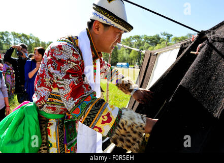 Yugur, Gansu, CHN. 18th Aug, 2015. Yugur, CHINA - August 18 2015: (EDITORIAL USE ONLY. CHINA OUTï¼‰Successor of Intagible Cultural Heritage Ke Cuilin held a wedding for her daughter, passing on the wedding heritage to the 90s youth on August 18 2015 morning. the Yugur ethnic minority group is heir of Uighur ethinic group, and divided as Western Yugur and Eastern Yugur mainly in Yugur Autonomous County Gansu. In 2011 their traditional wedding customs were on the 3rd National Intagible Cultural Heritage List. They insist monogamy, men and women share same Family name and same origin, or differe Stock Photo