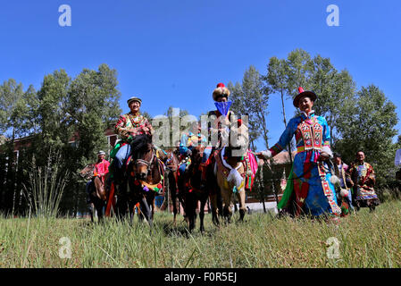 Yugur, Gansu, CHN. 18th Aug, 2015. Yugur, CHINA - August 18 2015: (EDITORIAL USE ONLY. CHINA OUTï¼‰Successor of Intagible Cultural Heritage Ke Cuilin held a wedding for her daughter, passing on the wedding heritage to the 90s youth on August 18 2015 morning. the Yugur ethnic minority group is heir of Uighur ethinic group, and divided as Western Yugur and Eastern Yugur mainly in Yugur Autonomous County Gansu. In 2011 their traditional wedding customs were on the 3rd National Intagible Cultural Heritage List. They insist monogamy, men and women share same Family name and same origin, or differe Stock Photo