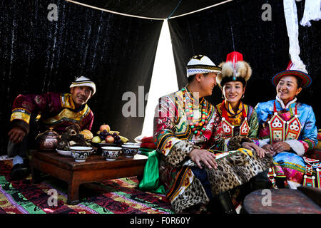 Yugur, Gansu, CHN. 18th Aug, 2015. Yugur, CHINA - August 18 2015: (EDITORIAL USE ONLY. CHINA OUTï¼‰Successor of Intagible Cultural Heritage Ke Cuilin held a wedding for her daughter, passing on the wedding heritage to the 90s youth on August 18 2015 morning. the Yugur ethnic minority group is heir of Uighur ethinic group, and divided as Western Yugur and Eastern Yugur mainly in Yugur Autonomous County Gansu. In 2011 their traditional wedding customs were on the 3rd National Intagible Cultural Heritage List. They insist monogamy, men and women share same Family name and same origin, or differe Stock Photo