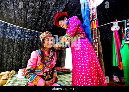 Yugur, Gansu, CHN. 18th Aug, 2015. Yugur, CHINA - August 18 2015: (EDITORIAL USE ONLY. CHINA OUTï¼‰Successor of Intagible Cultural Heritage Ke Cuilin held a wedding for her daughter, passing on the wedding heritage to the 90s youth on August 18 2015 morning. the Yugur ethnic minority group is heir of Uighur ethinic group, and divided as Western Yugur and Eastern Yugur mainly in Yugur Autonomous County Gansu. In 2011 their traditional wedding customs were on the 3rd National Intagible Cultural Heritage List. They insist monogamy, men and women share same Family name and same origin, or differe Stock Photo