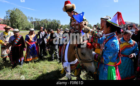 Yugur, Gansu, CHN. 18th Aug, 2015. Yugur, CHINA - August 18 2015: (EDITORIAL USE ONLY. CHINA OUTï¼‰Successor of Intagible Cultural Heritage Ke Cuilin held a wedding for her daughter, passing on the wedding heritage to the 90s youth on August 18 2015 morning. the Yugur ethnic minority group is heir of Uighur ethinic group, and divided as Western Yugur and Eastern Yugur mainly in Yugur Autonomous County Gansu. In 2011 their traditional wedding customs were on the 3rd National Intagible Cultural Heritage List. They insist monogamy, men and women share same Family name and same origin, or differe Stock Photo