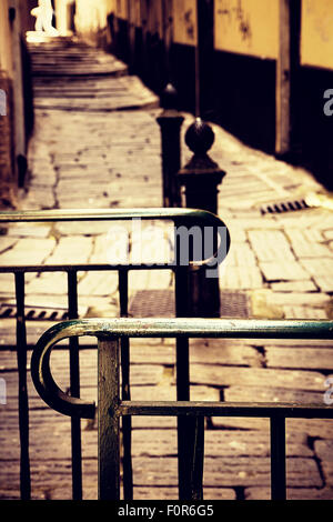 Pedestrians only barrage on a small narrow street in old town Genoa, Italy. Blurred background Stock Photo