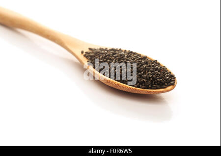Heap of black Sesame in wooden spoon isolated on white background, Selective focus Stock Photo