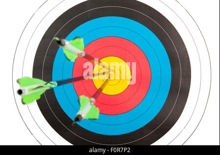 The bull's eye of an archery target with three arrows Stock Photo - Alamy