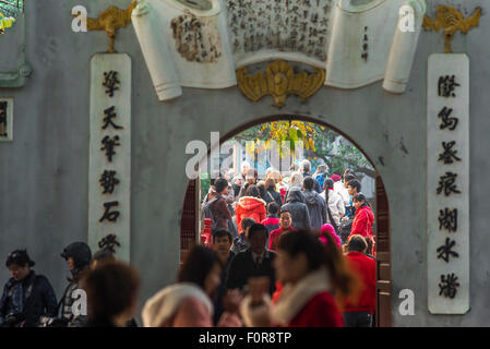 Hanoi tourists, view of tourists crowding the approach to Huc Bridge while visiting the Temple Of The Jade Mound (Den Ngoc Son) Hanoi, Vietnam Stock Photo