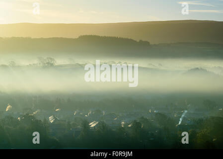 Early morning mist hangs over Caton and Brookhouse in the Lune valley Lancashire below the Bowland Fells Stock Photo