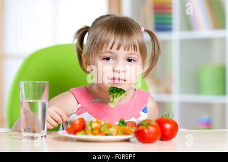 kid eating healthy food in kindergarten or at home Stock Photo