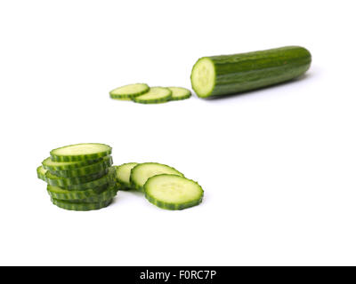 close up shot of chopped and sliced cucumber isolated on a pure white background with copy space for the designer. Stock Photo