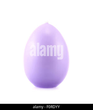 Egg shaped lilac colored wax candle isolated over the white background Stock Photo