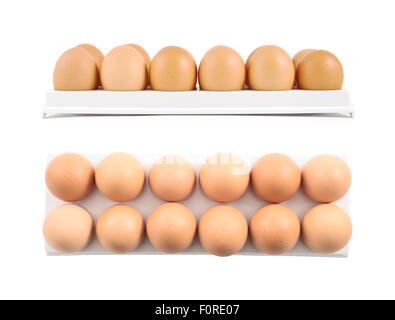 Dozen, twelve eggs in a special plastic case isolated over white background, set of two different foreshortenings Stock Photo