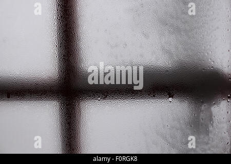 condensation on the inside of a window of a mountain hut, snow outside Stock Photo