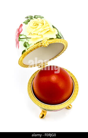 Egg box with red Easter egg isolated on white