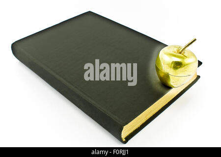 Golden apple on old book isolated on white Stock Photo