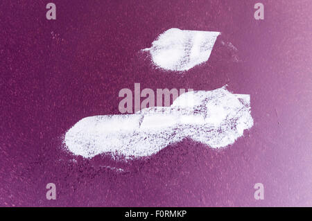 White plaster filler on a purple wall to fill in holes and blemishes Stock Photo