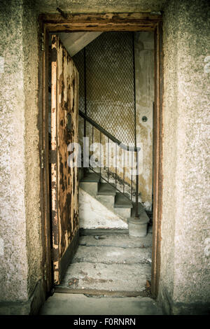 Doorway to abandoned staircase in old hospital Stock Photo