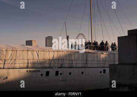 Guests aboard The HQS Wellington a private events venue moored on the Thames in London Stock Photo