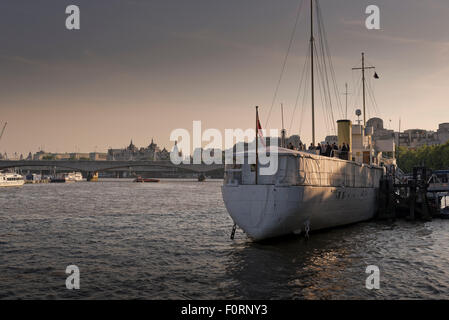 Guests aboard The HQS Wellington a private events venue moored on the Thames in London Stock Photo